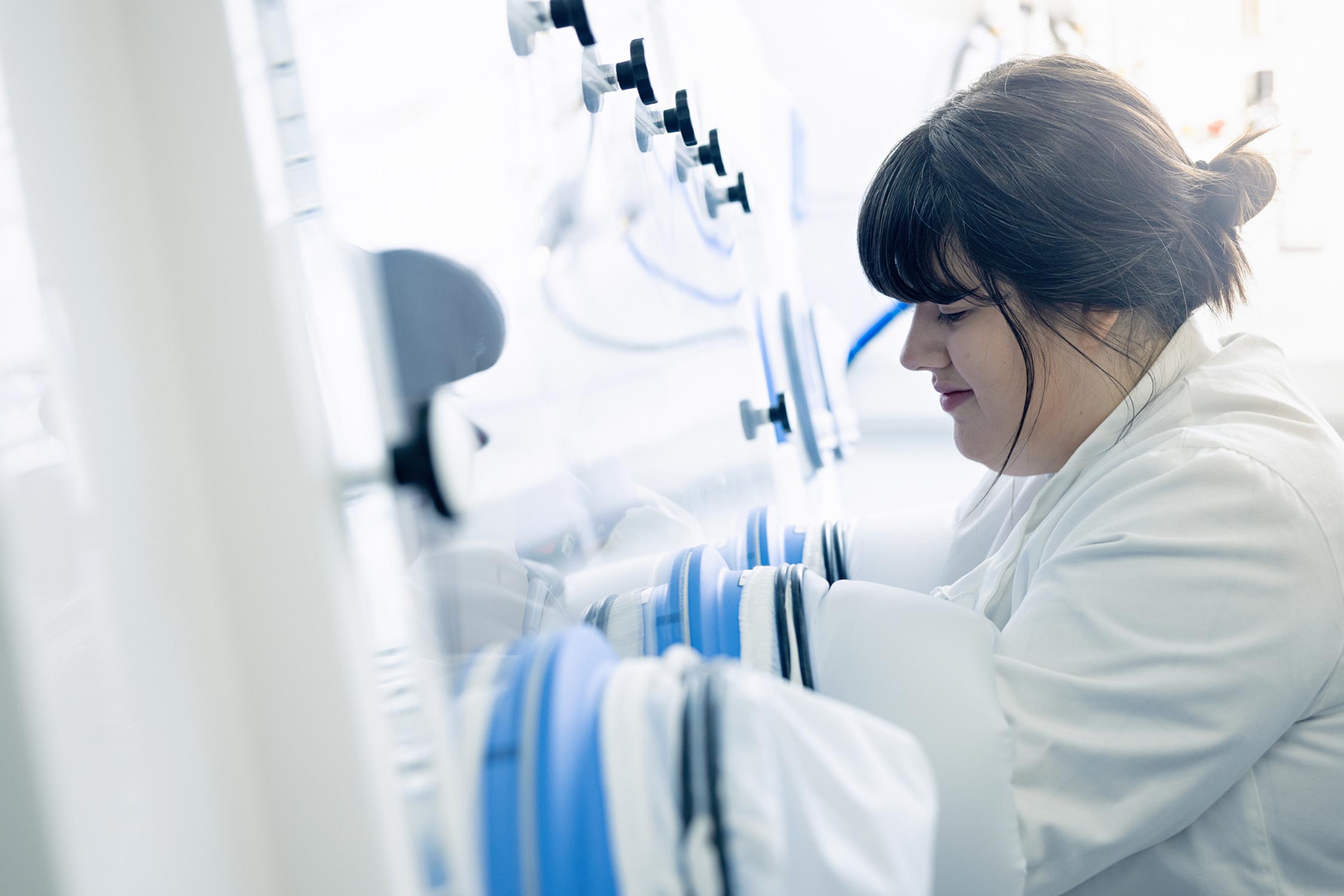 Researcher performing an experiment in a low oxygen chamber